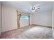 Spacious bedroom has neutral carpet, ceiling fan and big window with elegant curtains at 13472 E Dakota Ave, Aurora, CO 80012