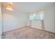 Bedroom offers bright natural light from the window, neutral carpet, with hanging lamp at 13472 E Dakota Ave, Aurora, CO 80012
