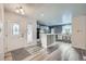 The entryway leads into a kitchen with a center island, sleek countertops and modern cabinetry at 13472 E Dakota Ave, Aurora, CO 80012