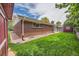 Brick home with a well-maintained lawn, a red shed, and clean gutters, showcasing its outdoor appeal at 13472 E Dakota Ave, Aurora, CO 80012