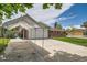 Brick home with an attached garage, concrete driveway with a car port, and well maintained lawn at 13472 E Dakota Ave, Aurora, CO 80012