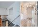 Hallway with wood floors, mirror and built in shelves leads to additional rooms at 13472 E Dakota Ave, Aurora, CO 80012
