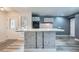 The kitchen features an island with a marble countertop, modern appliances, and white cabinetry with dark trim at 13472 E Dakota Ave, Aurora, CO 80012