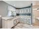 A well-lit kitchen with white cabinets, contrasting trim, modern appliances, and a stainless steel sink beneath the window at 13472 E Dakota Ave, Aurora, CO 80012