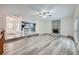 Open floor plan of a living room flowing into a kitchen, fireplace, and wood floors throughout at 13472 E Dakota Ave, Aurora, CO 80012