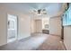 Large main bedroom featuring neutral carpet, fan, makeup vanity, and walk in closet at 13472 E Dakota Ave, Aurora, CO 80012