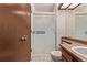 Bathroom with sliding glass shower door and wood vanity at 309 Pheasant Run, Louisville, CO 80027