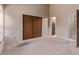 Spacious bedroom with wood closet doors and neutral wallpaper at 309 Pheasant Run, Louisville, CO 80027