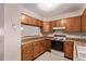 Well-maintained kitchen showcasing classic cabinets and functional layout at 309 Pheasant Run, Louisville, CO 80027