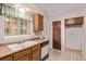 Bright kitchen with vintage cabinetry, durable countertops, and stainless steel sink at 309 Pheasant Run, Louisville, CO 80027