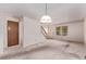 Open-concept living area with carpet flooring, wood staircase, and an entry door at 309 Pheasant Run, Louisville, CO 80027