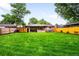 Expansive backyard featuring lush green grass and a wood fence at 1810 S Kearney St, Denver, CO 80224