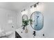 Modern bathroom with dual sinks, sleek lighting, and stylish fixtures at 1810 S Kearney St, Denver, CO 80224