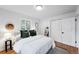 Inviting bedroom with hardwood floors, natural light, and a convenient en-suite bathroom at 1810 S Kearney St, Denver, CO 80224