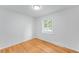 Simple bedroom with hardwood floors, fresh paint, and natural light at 1810 S Kearney St, Denver, CO 80224