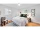 Bright bedroom with white walls, hardwood floors, a cozy rug, and a comfortable-looking bed at 1810 S Kearney St, Denver, CO 80224