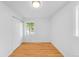 Bedroom featuring hardwood floors, closet, and window showcasing the view at 1810 S Kearney St, Denver, CO 80224