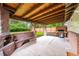 Inviting outdoor patio with a brick fireplace, bench seating, and stylish stamped concrete at 1810 S Kearney St, Denver, CO 80224