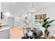 Eat-in kitchen with modern appliances, a view to the yard, and a round black dining table at 1810 S Kearney St, Denver, CO 80224