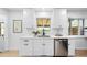 Bright kitchen features white cabinets, stainless steel appliances, and a window for natural light at 1810 S Kearney St, Denver, CO 80224