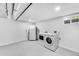 Well-lit laundry area featuring a washer, dryer, and refrigerator for added convenience at 1810 S Kearney St, Denver, CO 80224