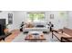 Well-lit living room features a plush sofa, stylish decor, and a view of the outdoors at 1810 S Kearney St, Denver, CO 80224