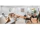 View of the living room showcasing hardwood floors, contemporary decor, and seamless transition to the kitchen at 1810 S Kearney St, Denver, CO 80224