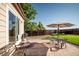 Cozy backyard patio featuring a dining set, grill, and lush landscaping, perfect for outdoor entertaining at 10482 Billings St, Commerce City, CO 80022