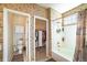 Bathroom featuring a vanity, toilet, walk-in closet, and shower-tub combination at 10482 Billings St, Commerce City, CO 80022