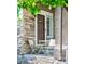 Cozy front porch with a table and chairs, stone accents, and a welcoming front door at 10482 Billings St, Commerce City, CO 80022
