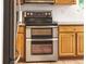 Stainless steel double oven and cooktop featured in this kitchen with oak cabinets and decorative backsplash at 10482 Billings St, Commerce City, CO 80022
