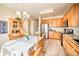 Bright kitchen with wood cabinets, stainless steel appliances, and an adjacent eat-in area at 10482 Billings St, Commerce City, CO 80022