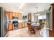 Eat-in kitchen featuring wood cabinets, stainless steel appliances, and a sliding glass door at 10482 Billings St, Commerce City, CO 80022