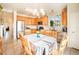 Well-lit eat-in kitchen with stainless steel appliances, wood cabinetry, and tile flooring at 10482 Billings St, Commerce City, CO 80022