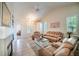 Bright living room with tile floors, comfortable couches, neutral colors, and an open floorplan at 10482 Billings St, Commerce City, CO 80022
