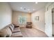Cozy living room with a comfortable sofa, armchair, and natural light streaming in through the window at 10482 Billings St, Commerce City, CO 80022