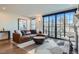 Stylish living room with leather sectional, area rug, and large windows offering lots of natural light at 4117 Quivas St, Denver, CO 80211