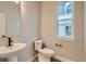 Bathroom features a modern sink, toilet, and a window for natural light at 2751 E 102Nd Pl, Thornton, CO 80229