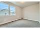 Bedroom with two windows and neutral-colored carpet at 2751 E 102Nd Pl, Thornton, CO 80229