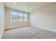 Well-lit bedroom features three windows and carpet flooring, offering ample natural light and comfort at 2751 E 102Nd Pl, Thornton, CO 80229