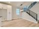 Modern dining area with hardwood floors, a staircase, and sleek lighting fixtures at 2751 E 102Nd Pl, Thornton, CO 80229