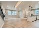 Open-concept living space connects to a modern kitchen with an island and white cabinets at 2751 E 102Nd Pl, Thornton, CO 80229