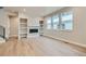 Bright living room features hardwood floors, built-in shelving, and a modern fireplace at 2751 E 102Nd Pl, Thornton, CO 80229