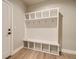 Organized mudroom features built-in shelving and hooks for storage, with wood flooring at 2751 E 102Nd Pl, Thornton, CO 80229