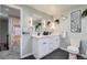 Stylish bathroom featuring double vanity, modern fixtures, and sleek black tile flooring at 7823 S Locust Ct, Centennial, CO 80112