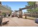 Inviting deck featuring a pergola, built-in benches, and a covered outdoor dining area at 7823 S Locust Ct, Centennial, CO 80112