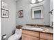 Stylish half bathroom with granite countertop, modern fixtures, and tiled floor at 7823 S Locust Ct, Centennial, CO 80112