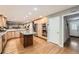 Spacious kitchen featuring stainless steel appliances, granite countertops and a dark wood center island at 7823 S Locust Ct, Centennial, CO 80112