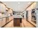 Open kitchen with light wood cabinets, stainless steel appliances, and a granite-topped island at 7823 S Locust Ct, Centennial, CO 80112