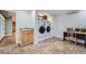 Convenient laundry room featuring tile flooring, sink, and modern appliances at 7823 S Locust Ct, Centennial, CO 80112